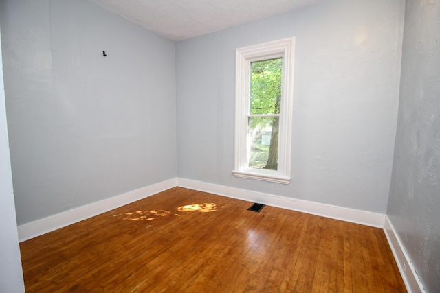 empty room with wood-type flooring