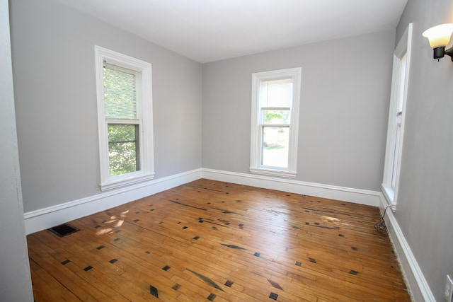 spare room with hardwood / wood-style floors