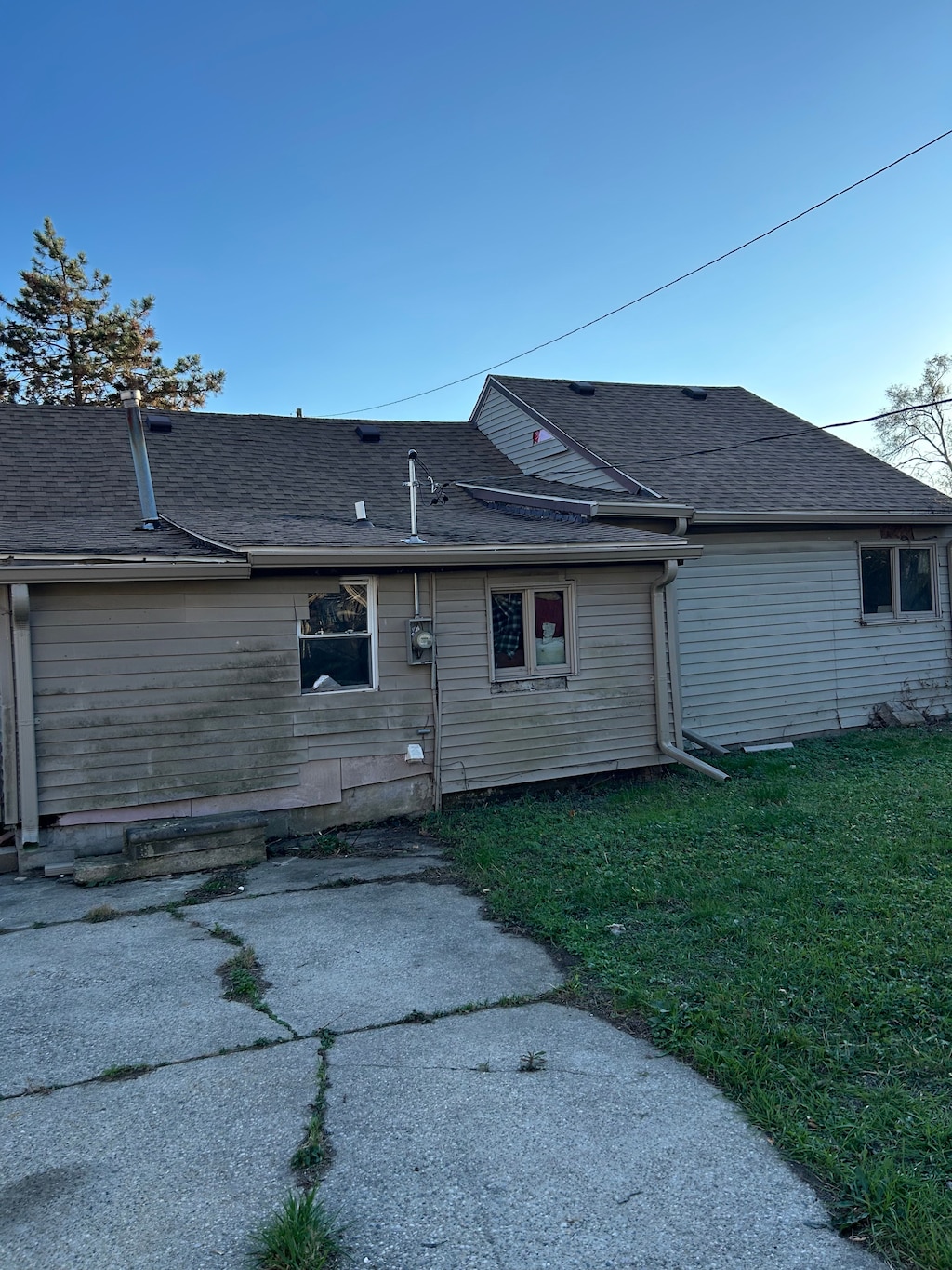 rear view of property featuring a yard