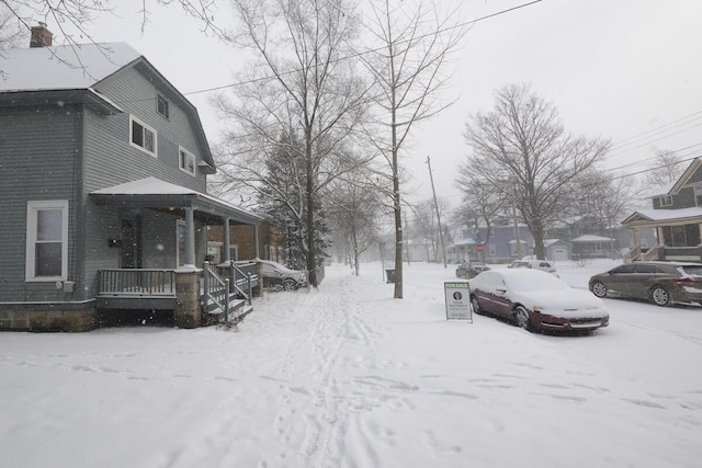 snowy yard with covered porch