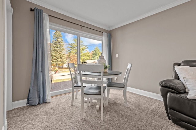 dining space with crown molding and carpet floors