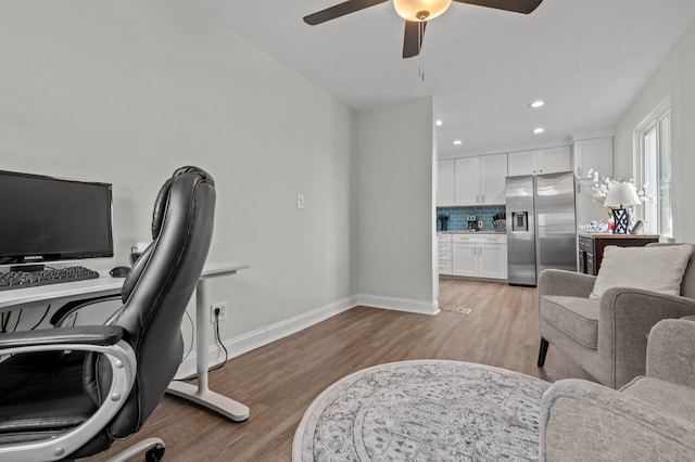 office space featuring ceiling fan and light wood-type flooring