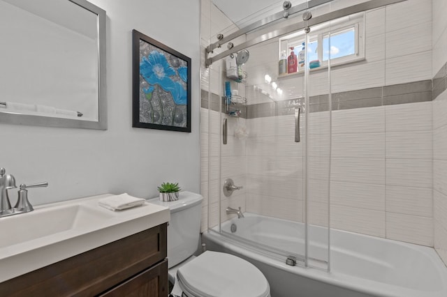 full bathroom with shower / bath combination with glass door, vanity, and toilet