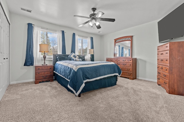 carpeted bedroom featuring ceiling fan and a closet