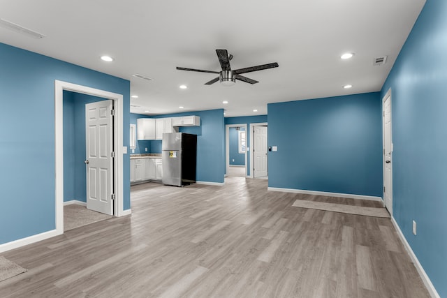 unfurnished living room featuring light hardwood / wood-style floors and ceiling fan