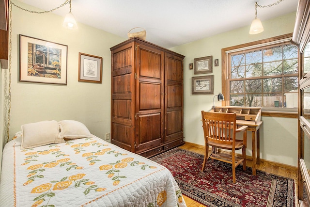 bedroom with wood-type flooring