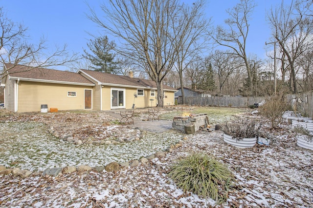 snow covered property with a patio area and a fire pit