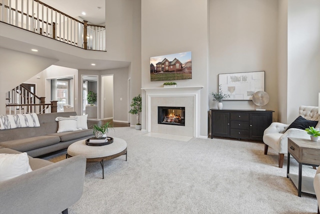 living room with carpet flooring and a high ceiling