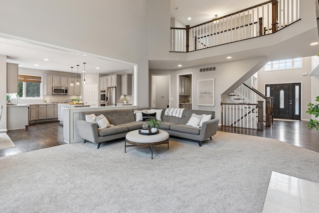 living room featuring dark colored carpet and a towering ceiling