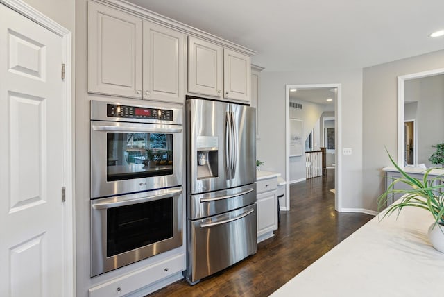 kitchen with stainless steel appliances and dark wood-type flooring