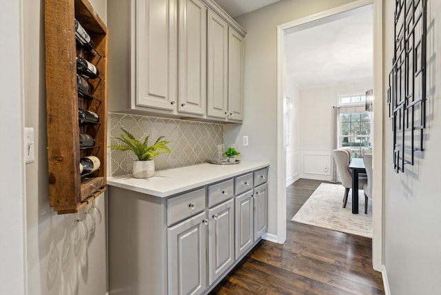 bar featuring tasteful backsplash, gray cabinets, and dark hardwood / wood-style floors