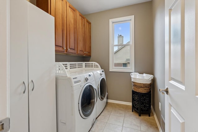 laundry room featuring cabinets, independent washer and dryer, and light tile patterned flooring