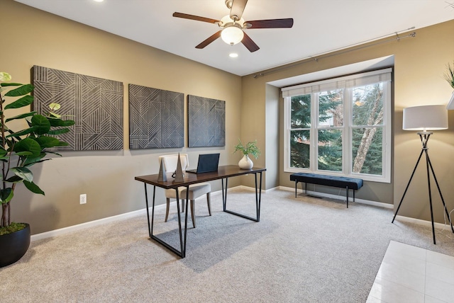 office space featuring light carpet and ceiling fan