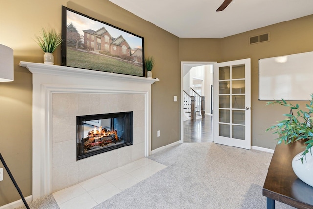 living room featuring ceiling fan and a fireplace