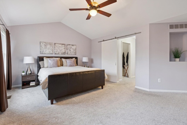 bedroom featuring a barn door, ceiling fan, light colored carpet, and lofted ceiling