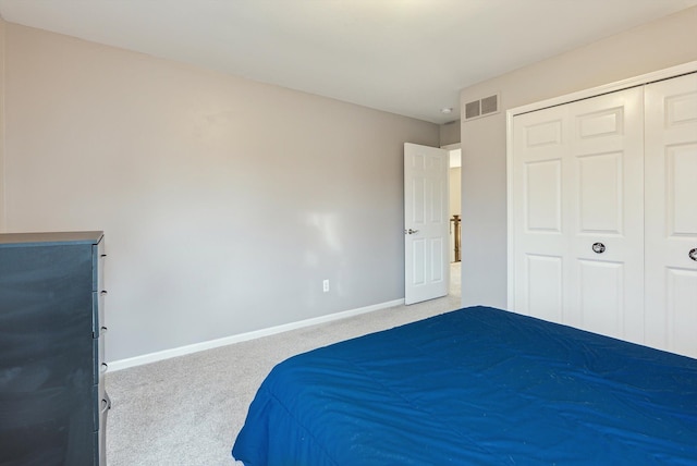 unfurnished bedroom with light colored carpet and a closet