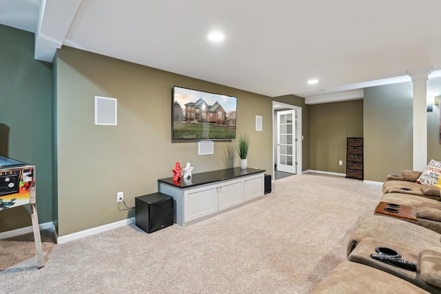 carpeted living room featuring french doors and decorative columns