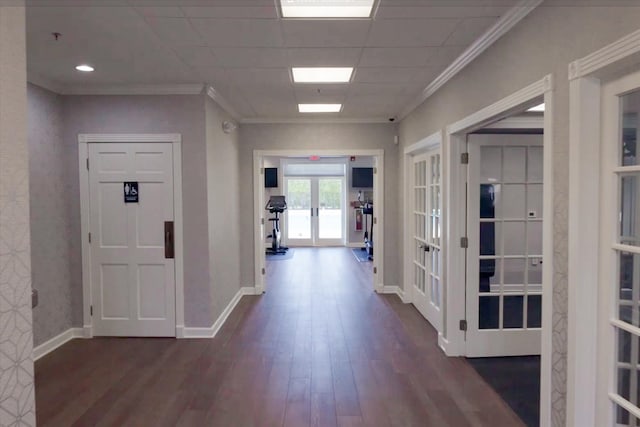 hallway featuring dark hardwood / wood-style flooring, french doors, and ornamental molding