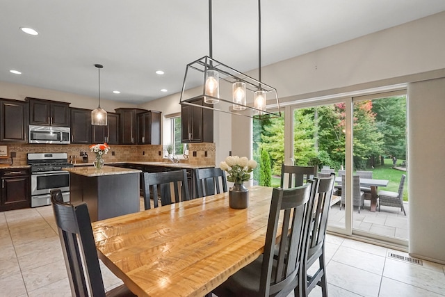 tiled dining space with a notable chandelier