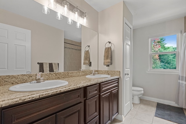 bathroom featuring tile patterned floors, vanity, and toilet