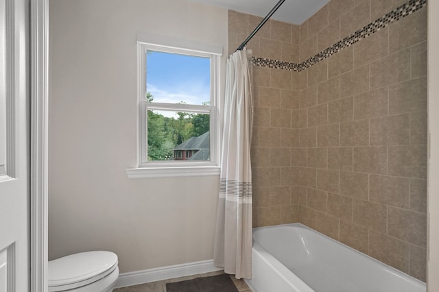 bathroom featuring tile patterned floors, shower / bath combination with curtain, and toilet