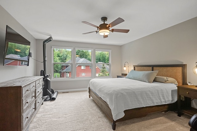 bedroom with ceiling fan and light carpet