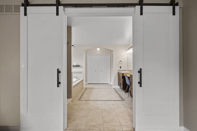 bathroom with vanity, tiled bath, and tile patterned floors