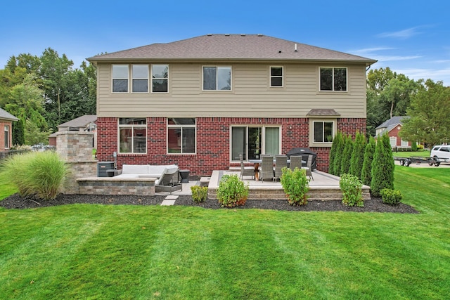 rear view of property featuring a lawn, outdoor lounge area, and a patio