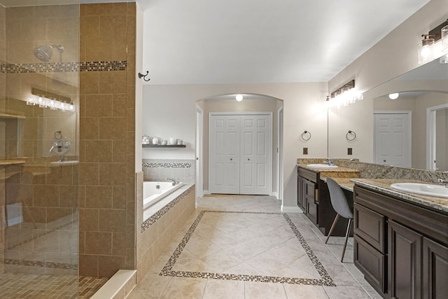 bathroom with tile patterned floors, separate shower and tub, and vanity