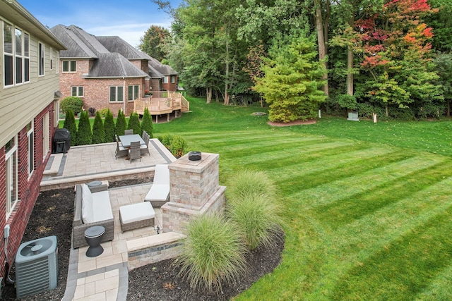 view of yard featuring an outdoor hangout area, central air condition unit, a patio, and a wooden deck