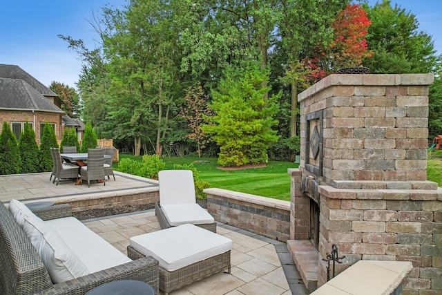 view of patio / terrace featuring an outdoor stone fireplace