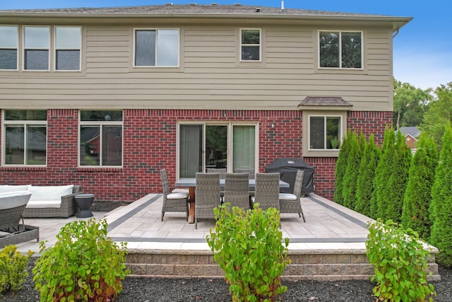 back of house featuring a patio and an outdoor hangout area