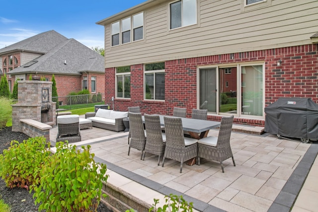 view of patio featuring an outdoor living space with a fireplace and area for grilling