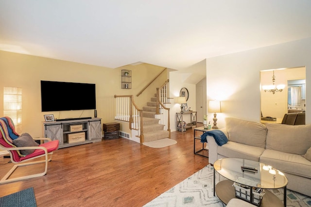 living room with hardwood / wood-style flooring and a chandelier