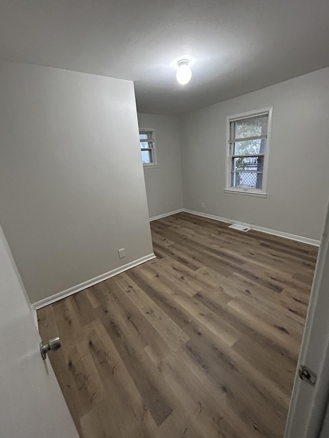 unfurnished room featuring dark hardwood / wood-style floors