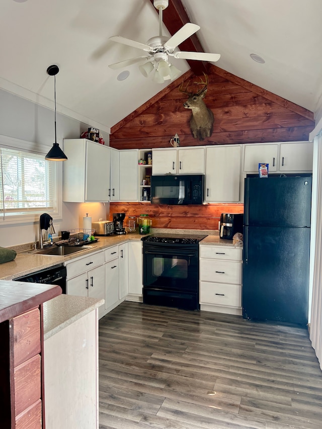 kitchen featuring vaulted ceiling with beams, dark hardwood / wood-style floors, decorative light fixtures, white cabinets, and black appliances