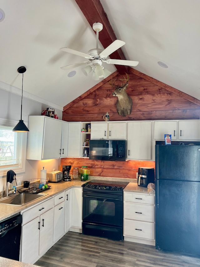 kitchen featuring sink, lofted ceiling with beams, pendant lighting, white cabinets, and black appliances