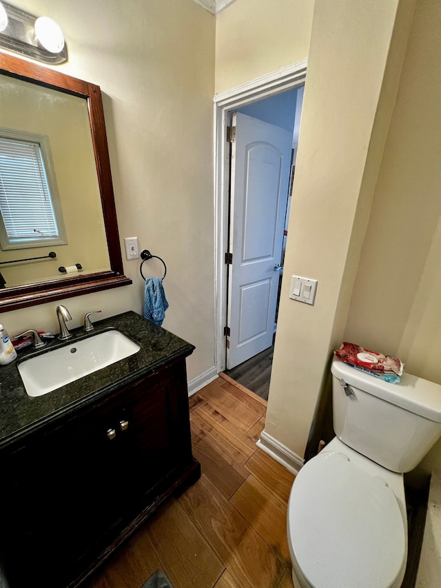 bathroom featuring hardwood / wood-style flooring, vanity, and toilet