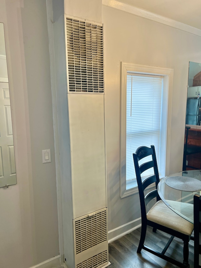 dining room featuring dark hardwood / wood-style floors and crown molding