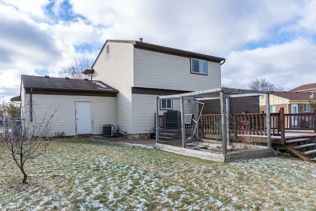 back of property featuring a lawn, a wooden deck, and central AC unit