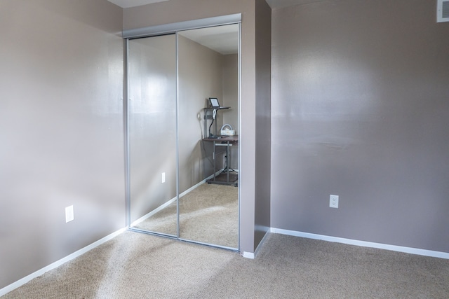 unfurnished bedroom featuring a closet and carpet