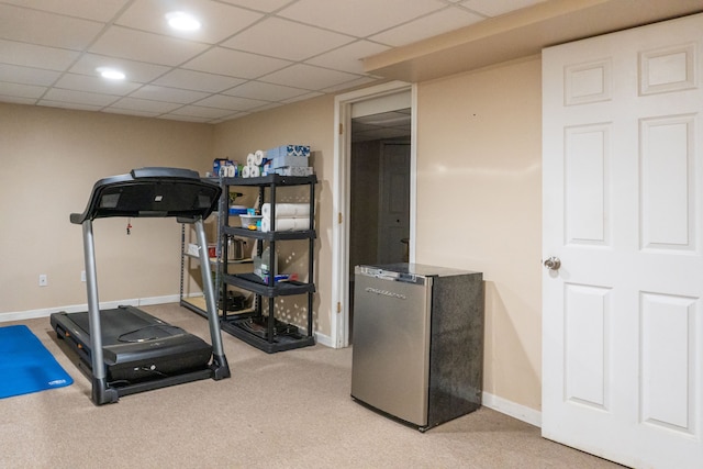 exercise room featuring light carpet