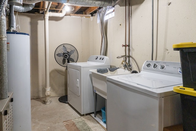 clothes washing area featuring washing machine and dryer and water heater