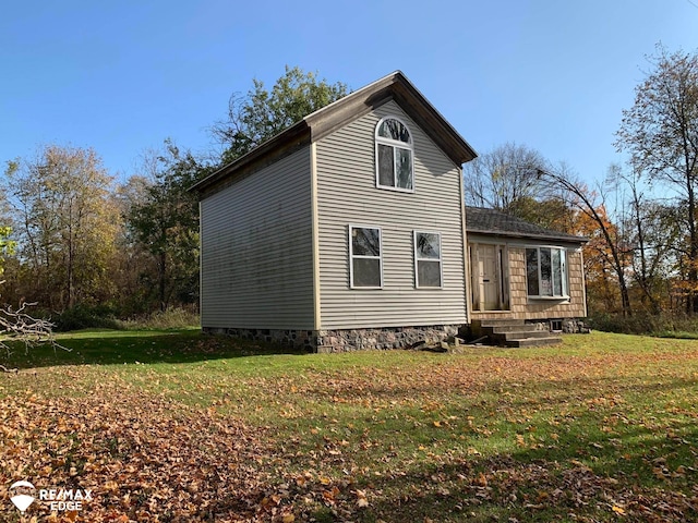 view of side of home featuring a lawn