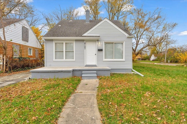 bungalow-style home featuring a front lawn