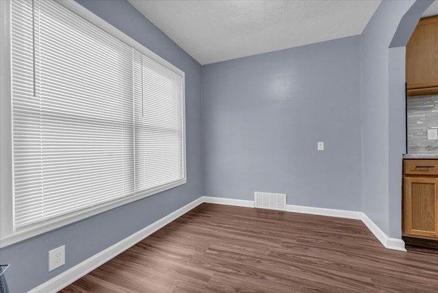 unfurnished dining area featuring dark hardwood / wood-style floors