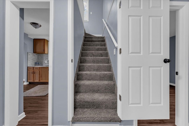 staircase featuring hardwood / wood-style floors