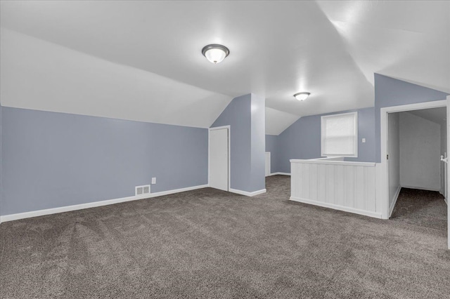 additional living space featuring carpet floors and lofted ceiling