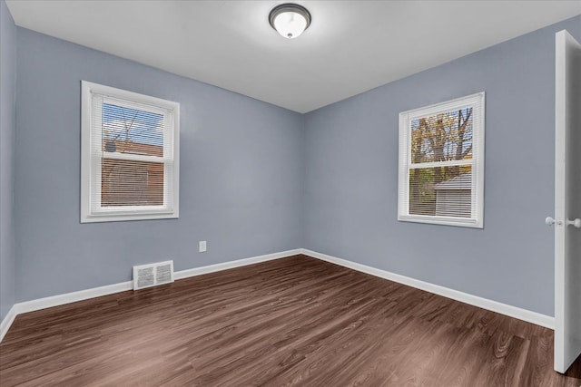 spare room featuring dark hardwood / wood-style floors