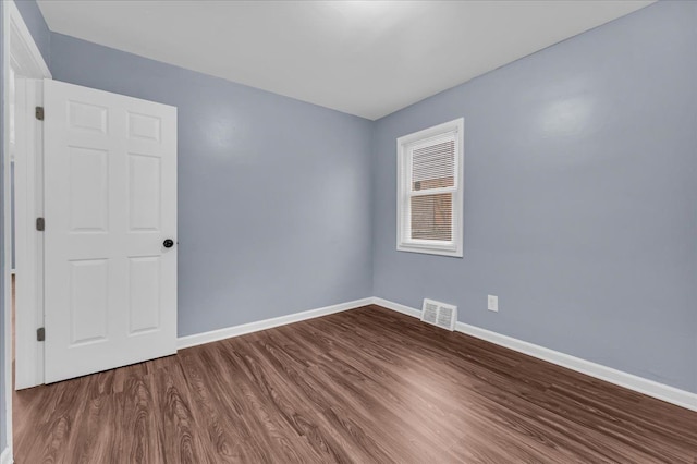 unfurnished room with hardwood / wood-style floors